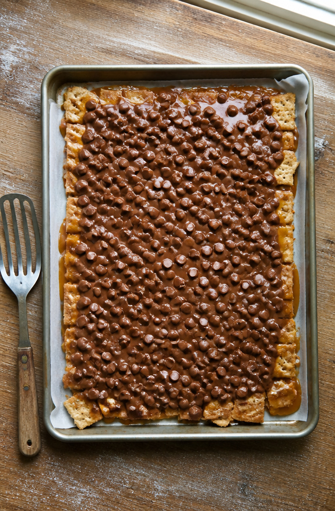 Christmas Treats with Graham Crackers: Crack, Bark, Toffee, Bars and S'mores 2 A baking sheet filled with graham crackers topped with toffee and chocolate.