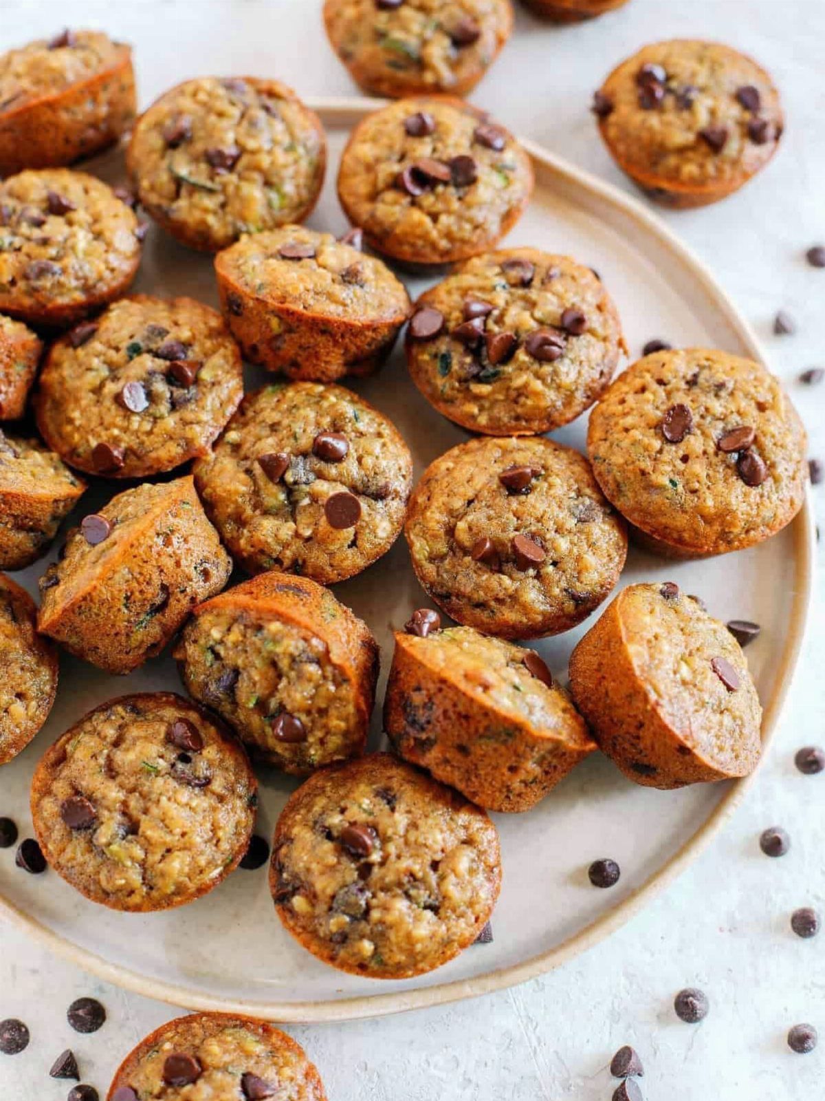 Baked oatmeal cups with chocolate chips arranged on a white ceramic plate.